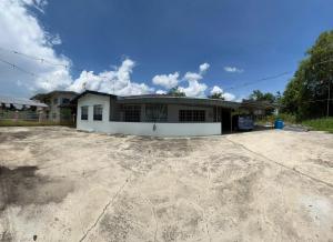 a house sitting on top of a dirt lot at Lingkudau Homestay in Keningau