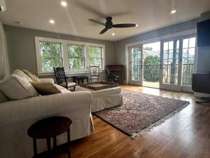 a living room with a couch and a table at Steps to Derby Wharf and Gables. in Salem