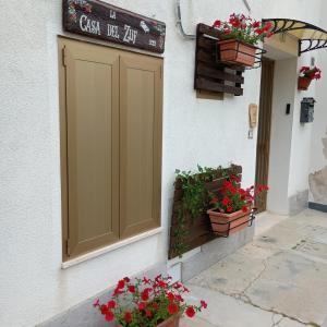 a door on the side of a building with potted plants at La Casa del Zuf in Carlino