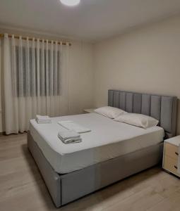 a bedroom with a large bed with white sheets at Floor Villa 2 in Vlorë