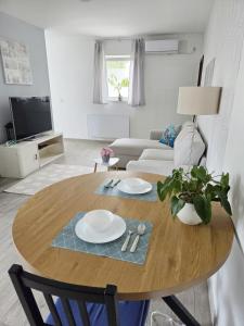 a living room with a table and a couch at Adriatic Pearl Korcula in Korčula +29 photos