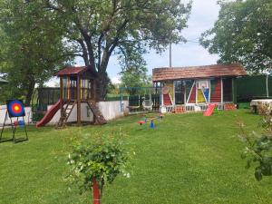 a backyard with a playground with a play structure at BANJANSKI RAJ in Arandelovac