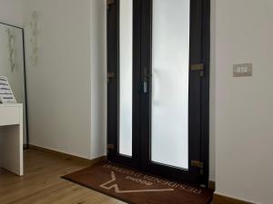 a door with a dog on a rug in a room at Residenza Dottavio in Montenero di Bisaccia