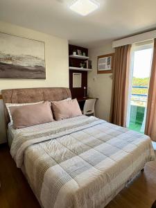 a bedroom with a bed and a desk and a window at Aesthetic 2 Bedroom The Loop Tower Condo Unit in Cagayan de Oro
