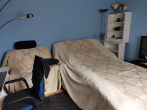 a bedroom with a bed and a desk with a chair at Room 2 in Kirkenes
