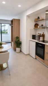a kitchen with a table and a stove top oven at Terrazza Suites in Paphos