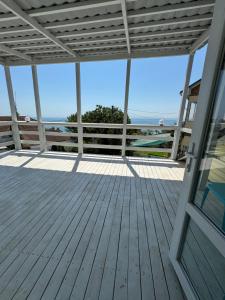 a large deck with a view of the ocean at Dacha Marella in Nova Dofinivka