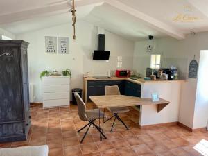 a kitchen with a table and chairs in a room at Le Cocon des Forges in Talmont