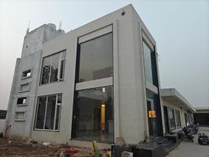 a building being constructed with large glass windows at Hotel Brijraj Dham in Govardhan