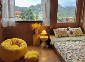 a bedroom with two beds and a large window at LYNH HOUSE - Đồng Văn in Dồng Văn