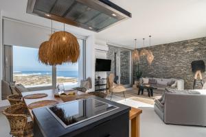 a living room with a view of the ocean at THEIA VILLA in Adamantas