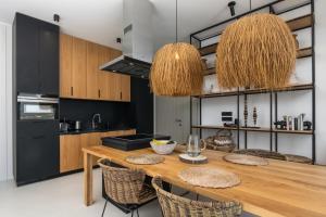 a kitchen with a wooden table and chairs at THEIA VILLA in Adamantas