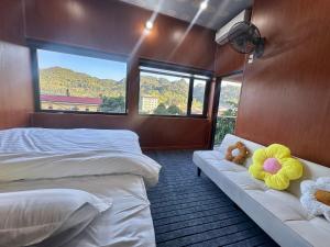 a bedroom with two beds and two teddy bears on a couch at LYNH HOUSE - Đồng Văn in Dồng Văn +29 photos