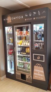 a mini supermarket with two refrigerators in a store at Campanile Lyon Est Aéroport Saint Exupery in Saint-Laurent-de-Mure