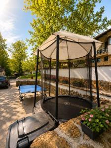 a trampoline with an umbrella on top of it at Комплекс Света Гора in Oreshak