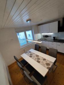 a kitchen with a table and chairs in a room at Apartments Justin in Bled