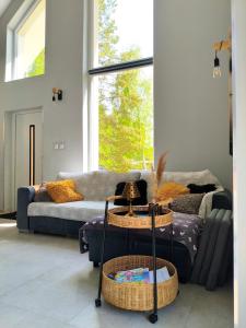 a living room with a couch and two tables at DOM LETNI Nakielno in Nakielno