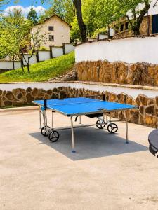 a blue ping pong table in front of a stone wall at Комплекс Света Гора in Oreshak