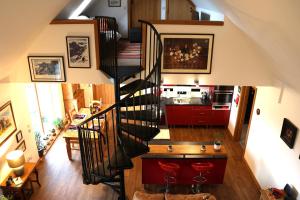 an overhead view of a kitchen and a staircase in a house at Modern, eco friendly house in Kildonan on Skye in Flashader