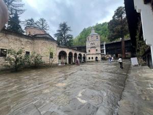 an old building with people walking around in a courtyard at Комплекс Света Гора in Oreshak +15 photos