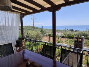 a view from the balcony of a house with a table at Thea Panorama in Makri