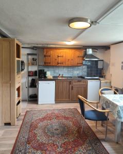 a kitchen with wooden cabinets and a table and chairs at YALET Ferienhaus 2 appartementen vlakbij Willingen in Brilon-Wald
