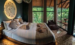 a bedroom with a large bed with towels on it at Nice View Guest House & Restaurant in Ella