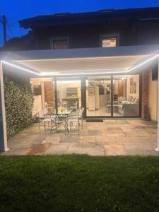 a patio with a table and chairs in front of a house at LUXURY vertical open space in Sangiano