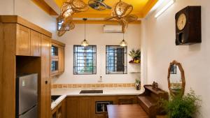 a kitchen with a sink and a clock on the wall at Local Homestay in Hanoi
