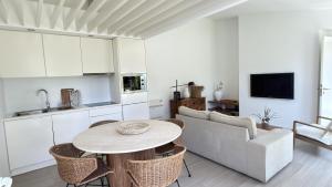 a kitchen and living room with a table and a couch at Quinta de Santa Clara in Ponta Delgada