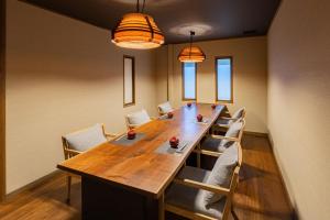 a long wooden table and chairs in a room at 鵜原館 -Ubarakan- in Katsuura +73 photos