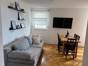 a living room with a couch and a table at M5 in Promajna