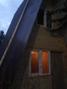 a house with orange and orange doors on the side at Ada chalet in Mărăcineni
