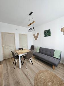 a living room with a table and a couch at 3-room apartment 2b in Thionville