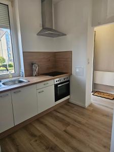 a kitchen with a sink and a stove top oven at 3-room apartment 2b in Thionville +6 photos