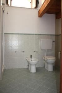 a bathroom with a toilet and a sink at Iaia Apartment in Sciacca