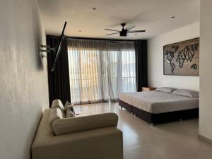 a bedroom with a bed and a couch in a room at Vistas del Angel in San Juan Cosalá +18 photos