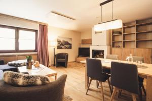 a living room with a table and chairs and a dining room at Hotel Johanna mitten im Ötztal in Umhausen