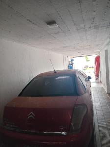 a red car is parked in a garage at Dambofamily in Necochea +3 photos