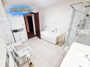 a bathroom with a tub and a toilet and a shower at Il Mulin Dell'Architetto in Fornaci di Barga +11 photos