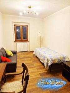 a living room with a bed and a couch at Il Mulin Dell'Architetto in Fornaci di Barga