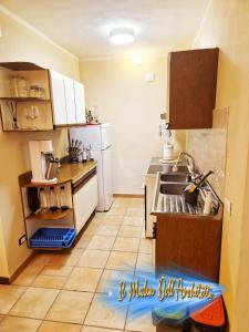 a small kitchen with a sink and a refrigerator at Il Mulin Dell'Architetto in Fornaci di Barga
