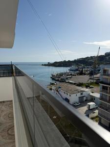 a view of the water from the balcony of a building at Sea You Soon Apartment in Shëngjin