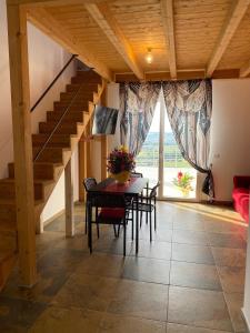 a dining room with a table and a staircase at Dimora Filippo in SantʼElpidio a Mare