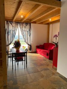 a living room with a red couch and a table at Dimora Filippo in SantʼElpidio a Mare