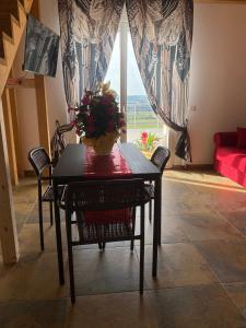 a dining room table with a vase of flowers on it at Dimora Filippo in SantʼElpidio a Mare