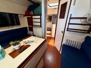 a living room with a couch and a table in a rv at Resort chic on the water! in Key West +28 photos