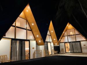 a building with large windows with the letters m on it at Wanderlust Beach Villa in Agatti