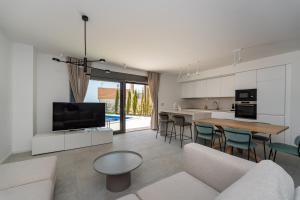 a living room with a couch and a table at Villa Cvita west in Primošten