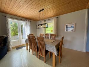 a dining room with a table and chairs at Spacious House with Fjordview in Lauvstad